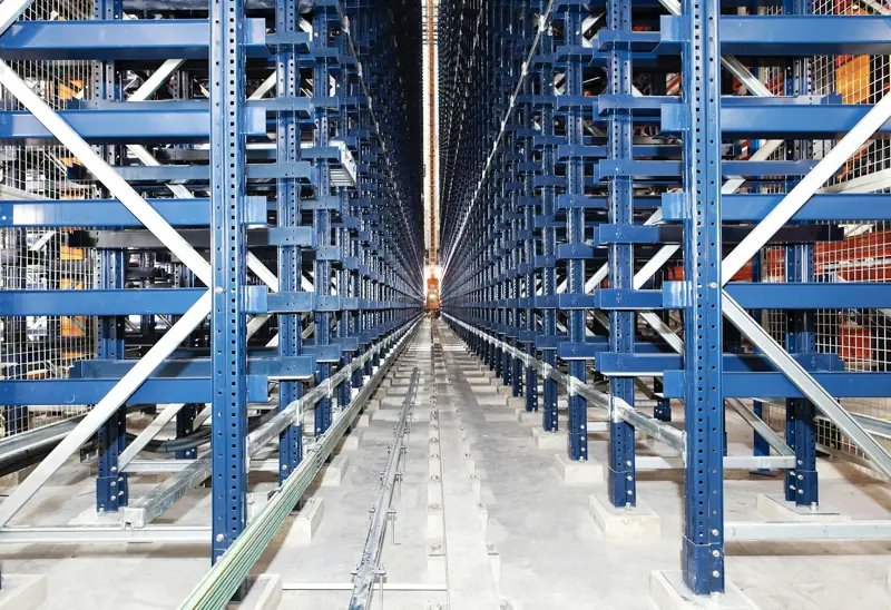 Aisle between tall steel racks in a unit-load automated storage system