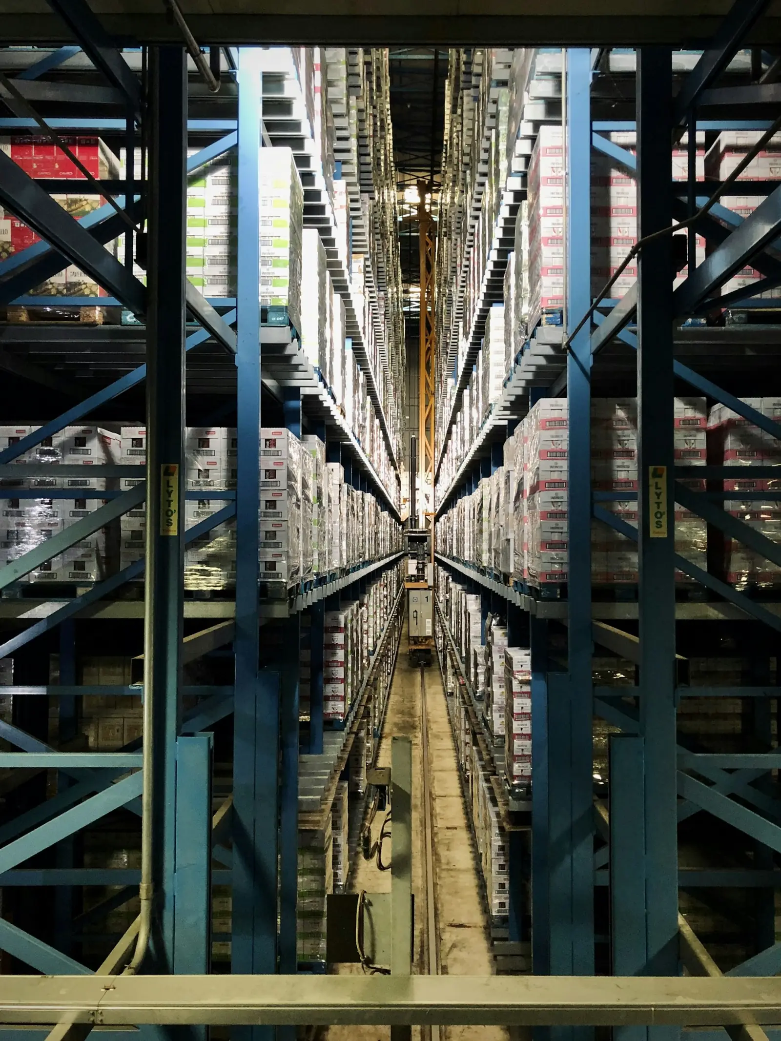 Looking down a long, narrow aisle of tall steel racking