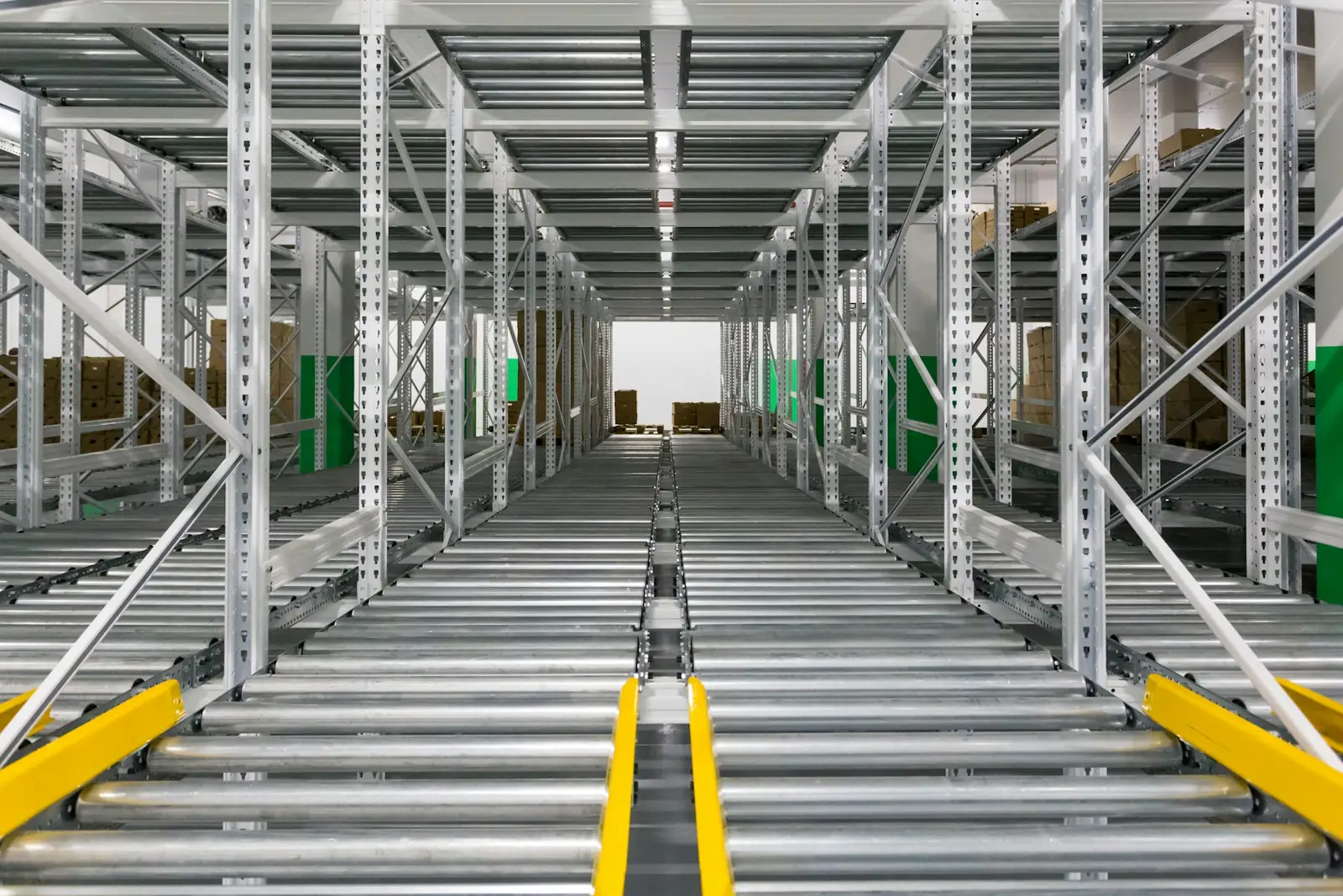 Rows of roller conveyor lanes running between steel racking
