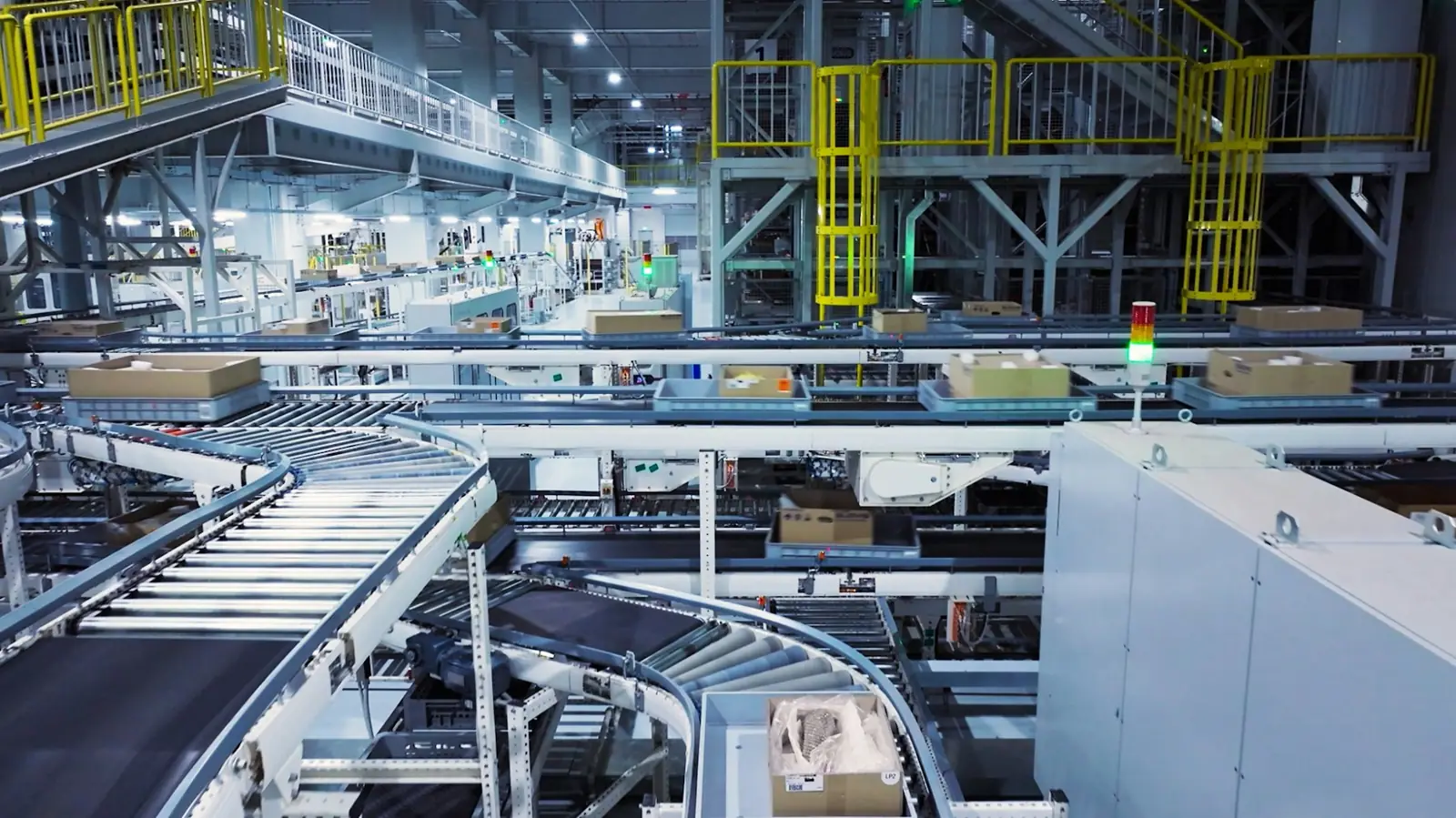 Cartons moving through a busy fulfillment center on conveyor and sortation lines